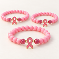 Pink beaded awareness bracelets with pink ribbon charms and sparkling pink accent beads