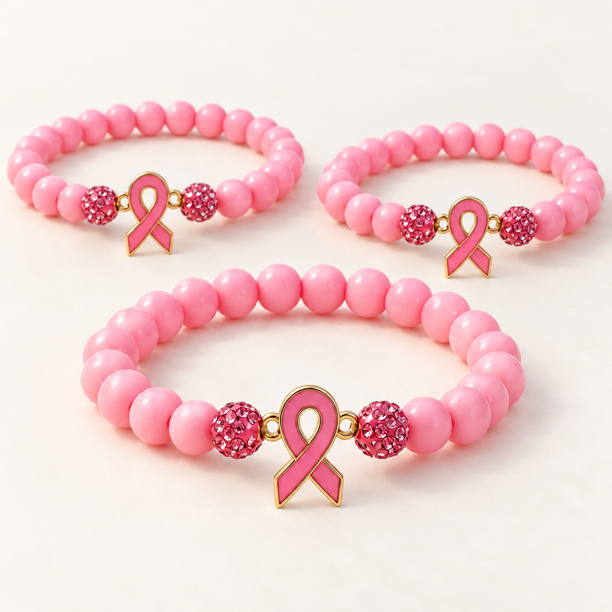 Pink beaded awareness bracelets with pink ribbon charms and sparkling pink accent beads